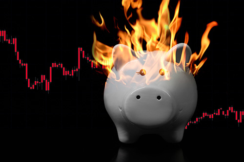 Piggy Bank on fire with digital chart on the background