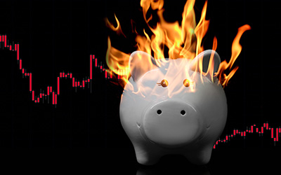 Piggy Bank on fire with digital chart on the background